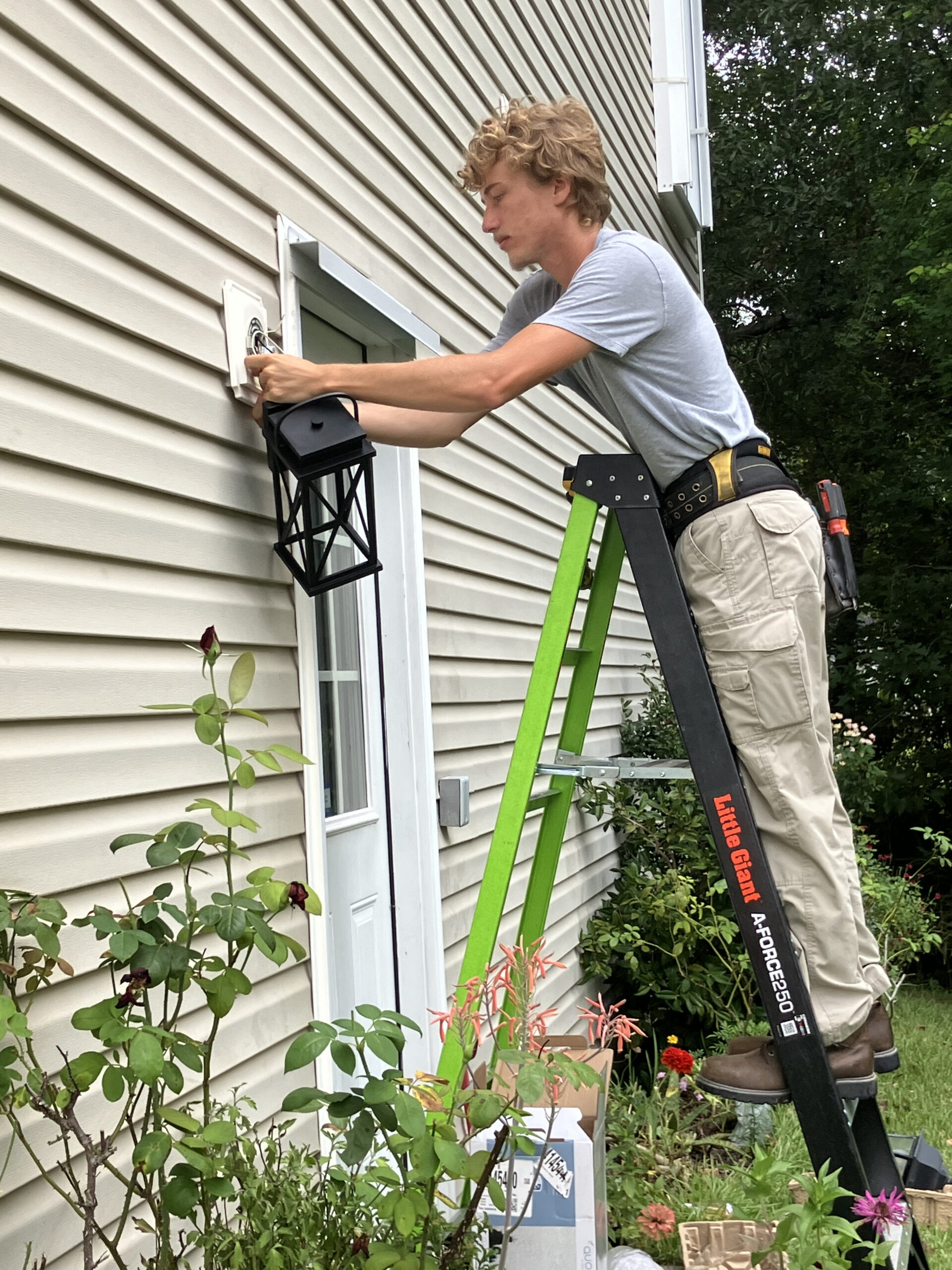 Tyler working on outdoor home light fixture